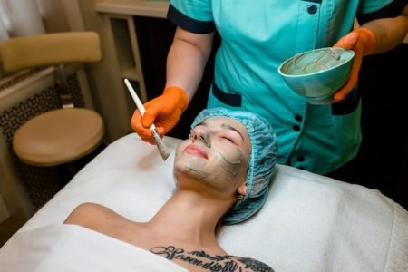 young-cropped-woman-cosmetologist-apply-white-clay-mask-woman-s-face-beautiful-caucasian-client-woman-beauty-salon-get-spa-procedures-cleansing-face-natural-beauty-cosmetology-concept_883